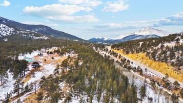 Eine gebirgige Landschaft mit einer durch ein bewaldetes Tal führenden Straße.