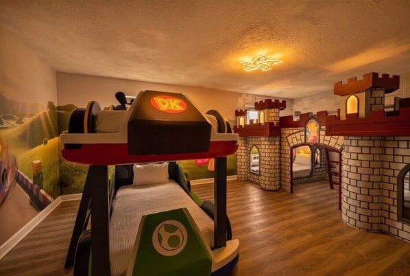 A children's play area with a castle-themed room, a play table, and a slide.