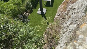 A lush garden with a swimming pool, outdoor seating, and a view of a river. - Château d'Aiguèze (Aiguèze)