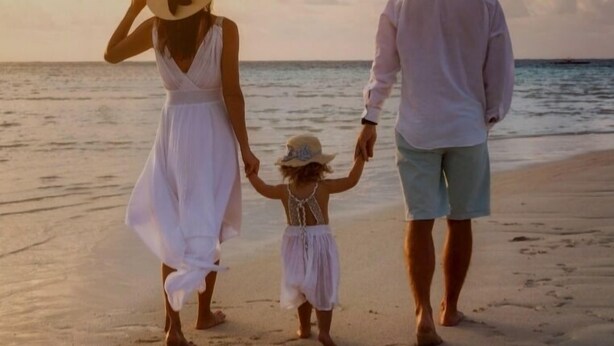 A family walking on a beach during sunset. - Samsara (Boossa)