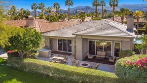 A covered patio with outdoor furniture, a pool, and a view of mountains. - Beautiful home away from home, nestled in the center of fabulous Indian Ridge CC (Palm Desert)
