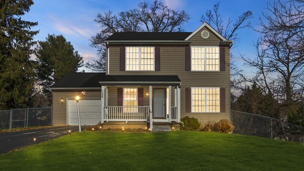 A two-story house with a front porch and a garage.