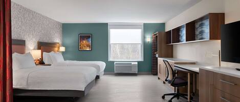 A hotel room with two beds, a desk, a chair, a TV, and a window with a view.