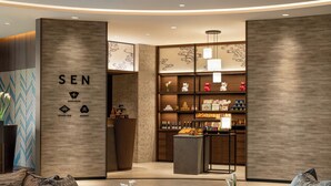 A modern interior with a reception desk, lounge area, and a market section. - DoubleTree by Hilton Osaka Castle (Osaka)