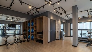 A modern gym with exercise equipment, wooden shelves with exercise balls, and large windows. - Wbe710 in S o Paulo (São Paulo)