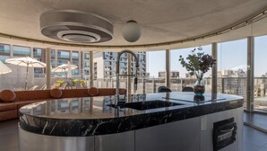 A modern kitchen with a central island, large windows, and a view of the city. - Freicaneca 111 in S o Paulo (São Paulo)