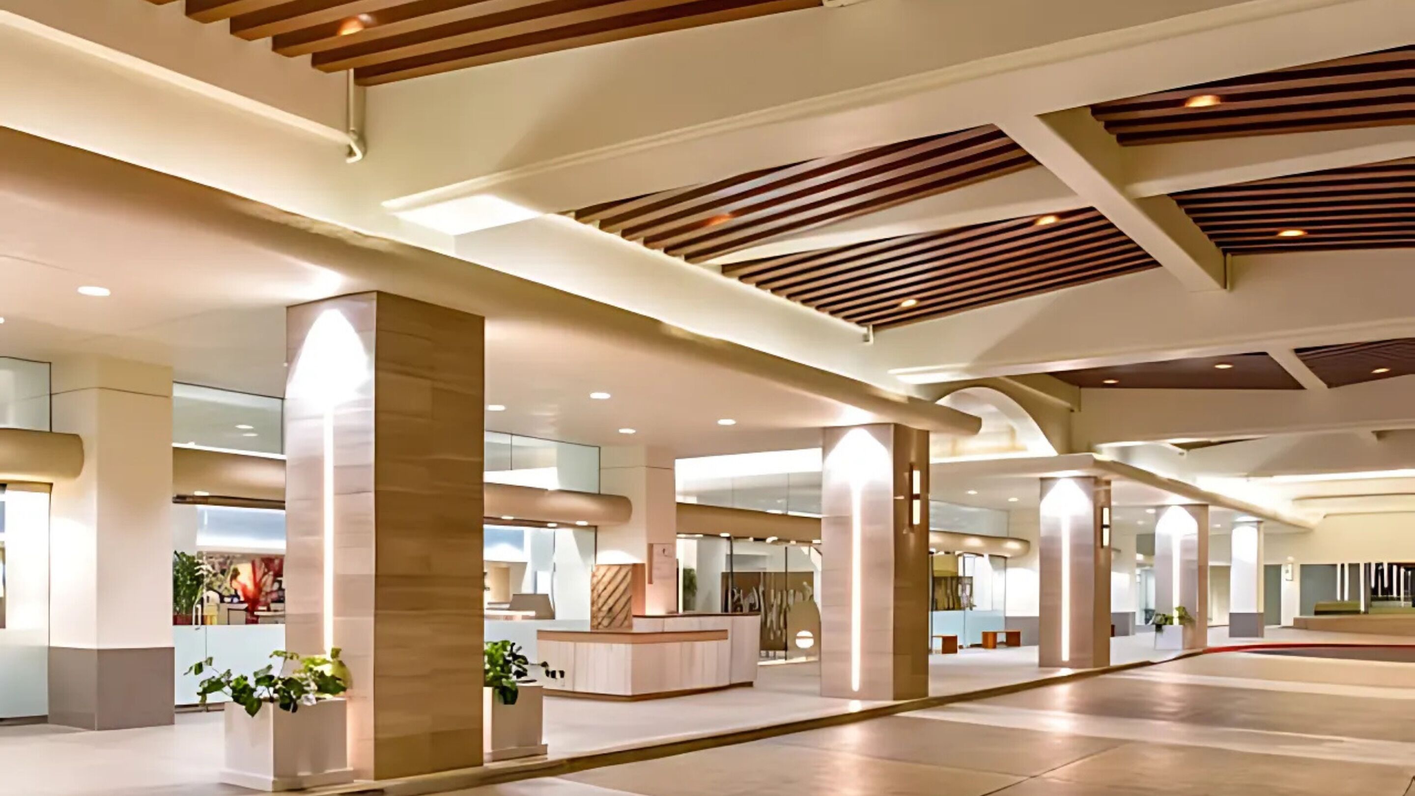 A spacious lobby with high ceilings, large pillars, and a modern design.
