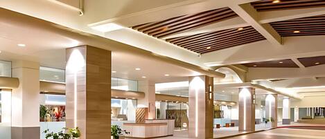 A spacious lobby with high ceilings, large pillars, and a modern design.