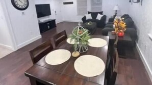 A dining area with a wooden table, four chairs, and a decorative centerpiece. - Sunset Melody - pet friendly  (Amarillo)