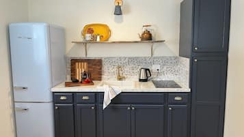 Fridge, microwave, coffee/tea maker, cookware/dishes/utensils