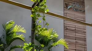 A building with a wooden shuttered wall and a sign that reads "Villa Mar".