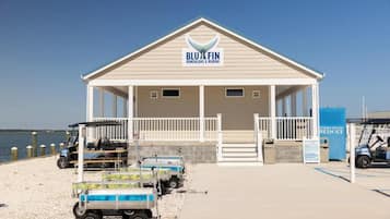 A beachside bungalows and marina with a covered seating area, a water filtration system, and golf carts.