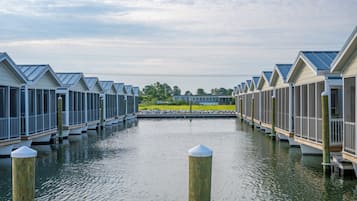 A row of waterfront cottages with a dock in the middle.