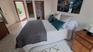 A bedroom with a bed, a nightstand, a dresser, and a painting on the wall. - Lovely Private House in Taganana - Anaga Rural Park (Santa Cruz de Tenerife)