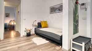 A modern bedroom with a bed, bedside table, and a wall-mounted phone. - GuestHost - Near the MIND neighborhood, the Milano Laghi highway, and in front of the Milano Certosa station near Rho Fiera, there's the two-room apartment with garage and garden at Casa Certosa&Mind, a new and welcoming space for three guests. Bright, w (Milan)