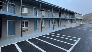 A multi-story motel with a parking lot in front. - Residency Inn & Studios (Waynesburg)