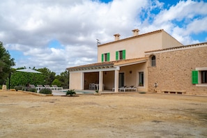 A two-story building with a covered patio, outdoor seating, and a pool. - Es Saquer de Son Coll - with private swimming pool (Algaida)
