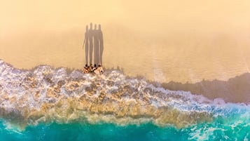 A beach scene with waves crashing onto the shore.