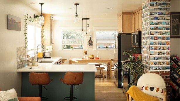 A modern kitchen with a central island, bar stools, wooden cabinets, and a refrigerator. - The Biggest Little House in Reno Midtown! Cozy Home Theatre  & Backyard BBQ (Reno)