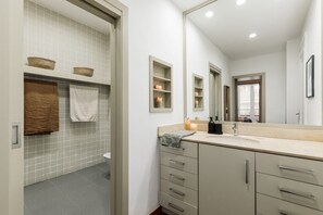 Enjoy a refreshing bathroom with a large mirror, vanity, and ample storage.
