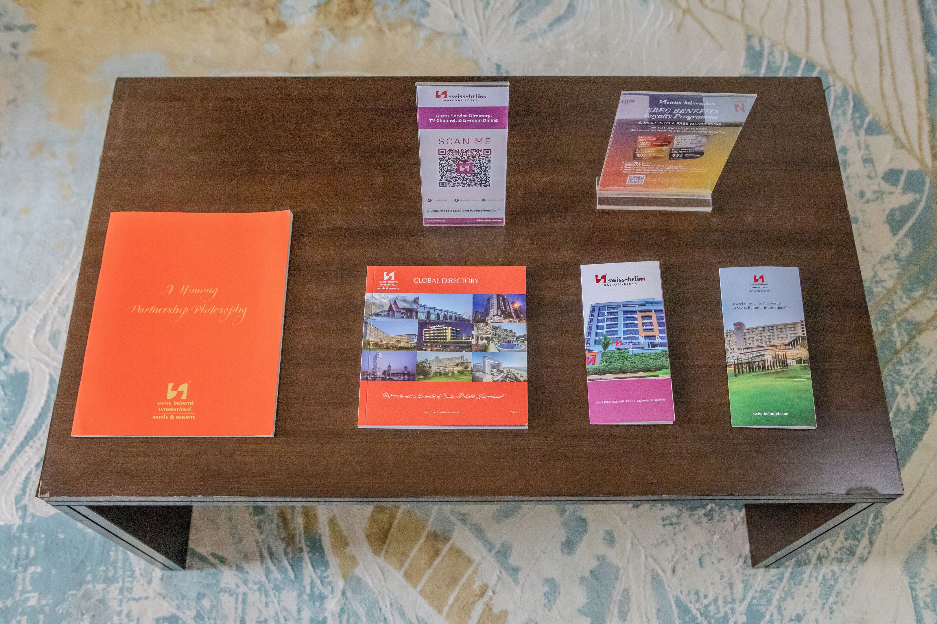 A wooden table with brochures and a book titled "A Journey Through Philosophy".