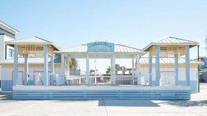 A beach boardwalk with a sign reading "Carolina Beach Boardwalk". - Coastal Cozy and Close to Beach with Turf Yard! (Carolina Beach)