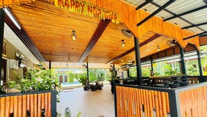 A covered outdoor area with bamboo railings, a 'Happy New Year' sign, and a 'Have a Good Day' mat. - AJ Paradise Resort (Krabi)