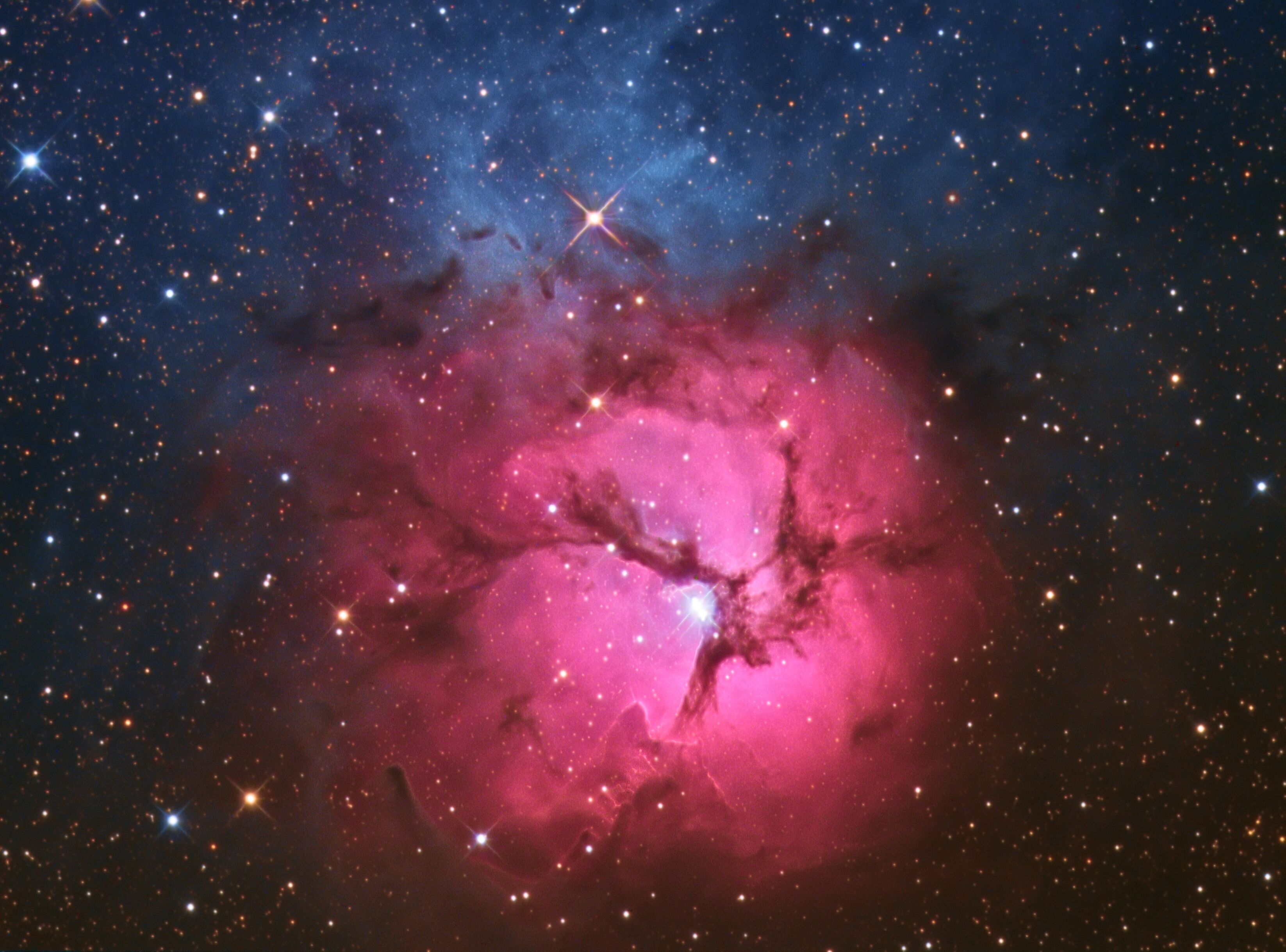 A starry night sky with a prominent nebula in the center.