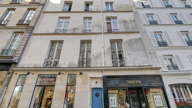 A multi-story building with a boutique store on the ground floor.