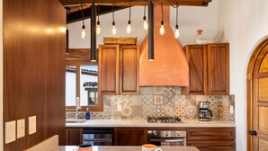A kitchen with wooden cabinets, a tiled backsplash, and a coffee maker on the counter. - Serene Paradise: Casa Leone 3 in Selva Romántica! 2BD Condo for rent in Old Tow (Puerto Vallarta)
