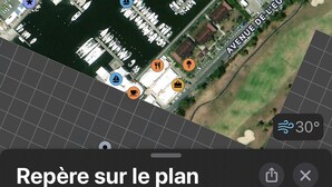 A satellite view of a marina with boats docked, surrounded by residential buildings and marked with various amenities icons. - Studio tout confort dans son écrin de verdure au pieds de la Marina (Saint-François)