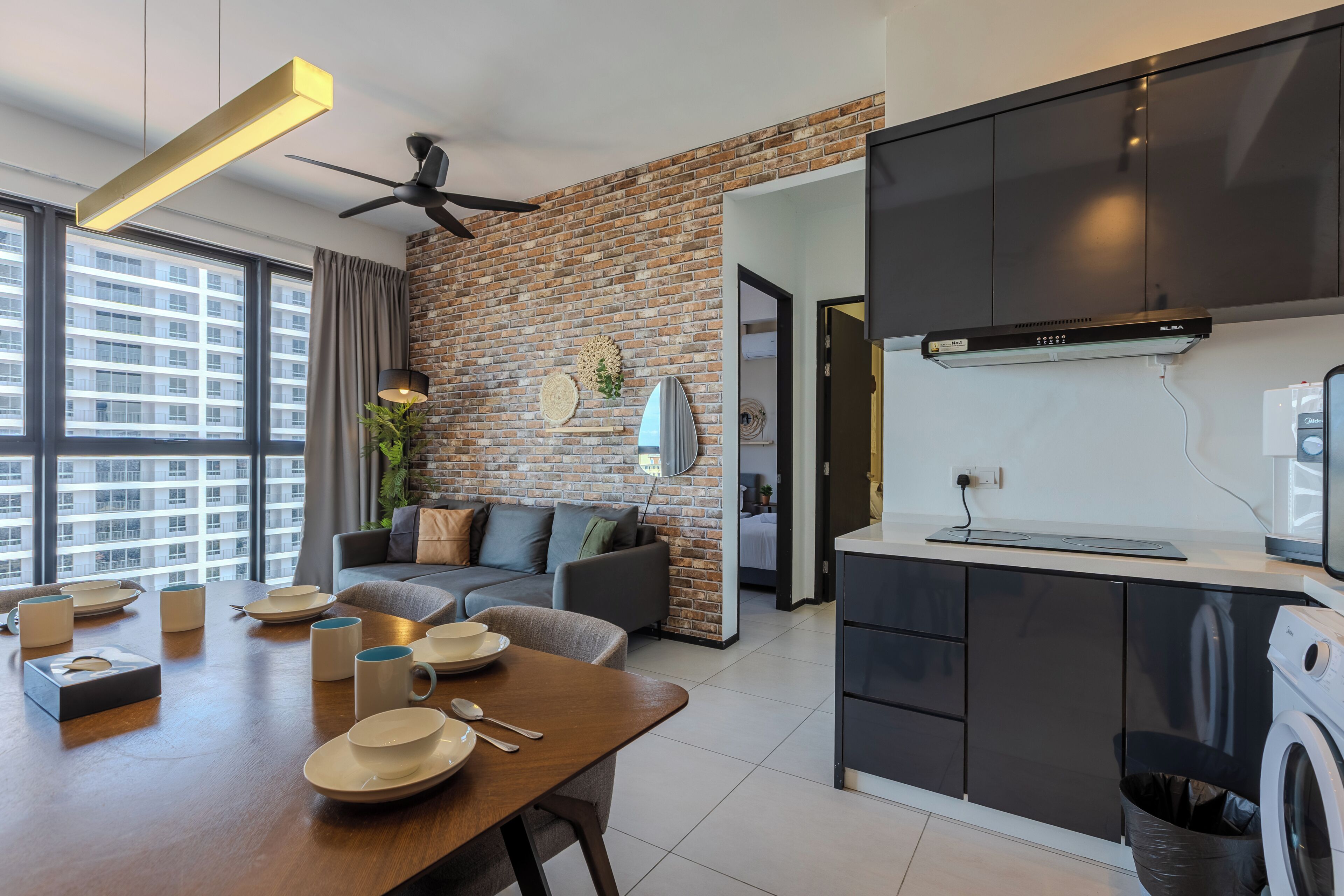 A modern apartment with a dining area, kitchen, and living space.