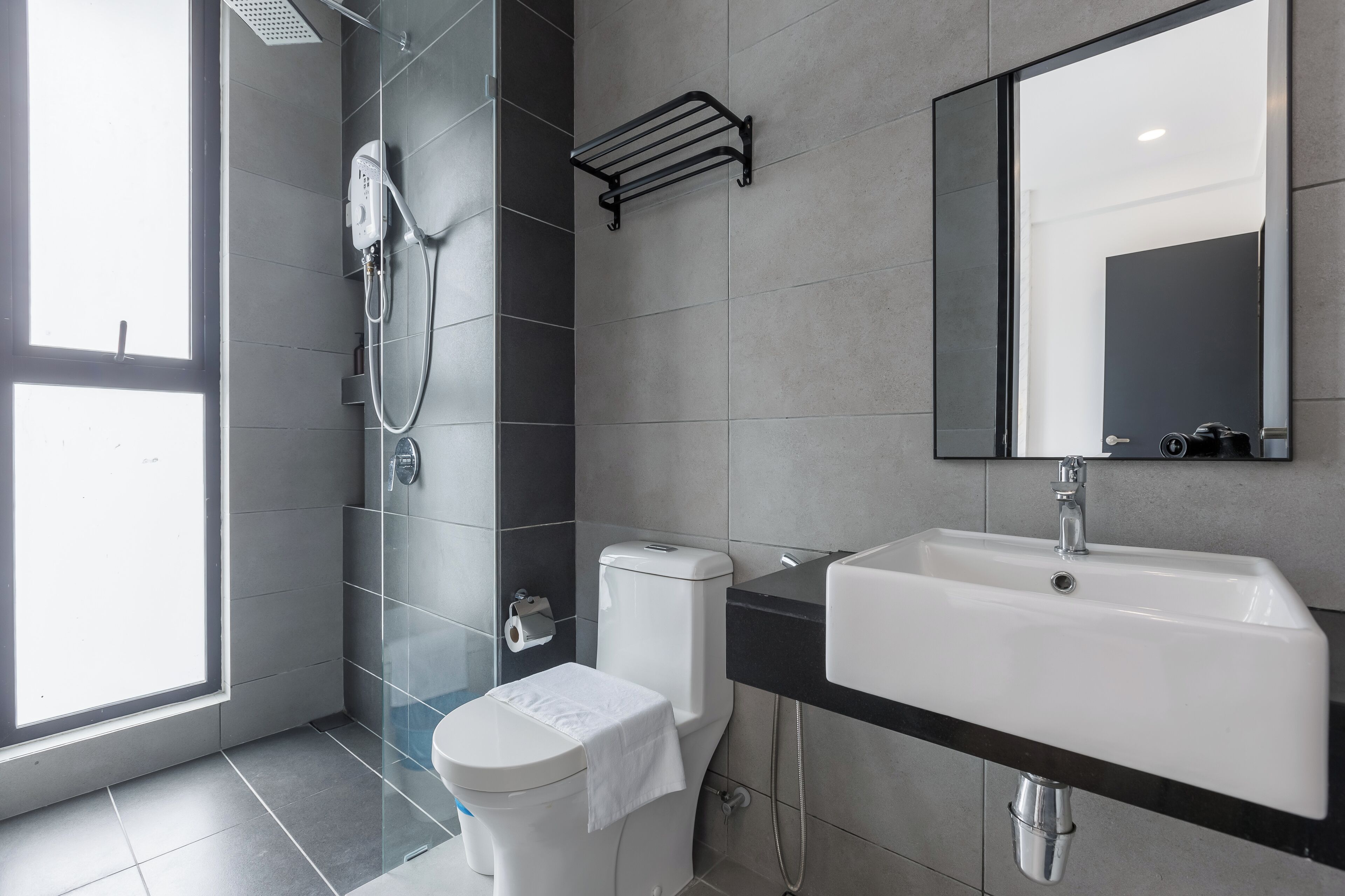 A modern bathroom with a toilet, bidet, and sink.