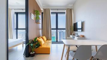 Basic Apartment, 3 Bedrooms | Living area | Flat-screen TV