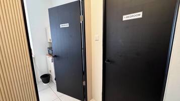 A hallway with two doors, one labeled '1-BEDROOM' and the other '2-BEDROOM'.