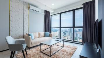 A modern living room with a sofa, a coffee table, and a TV stand.