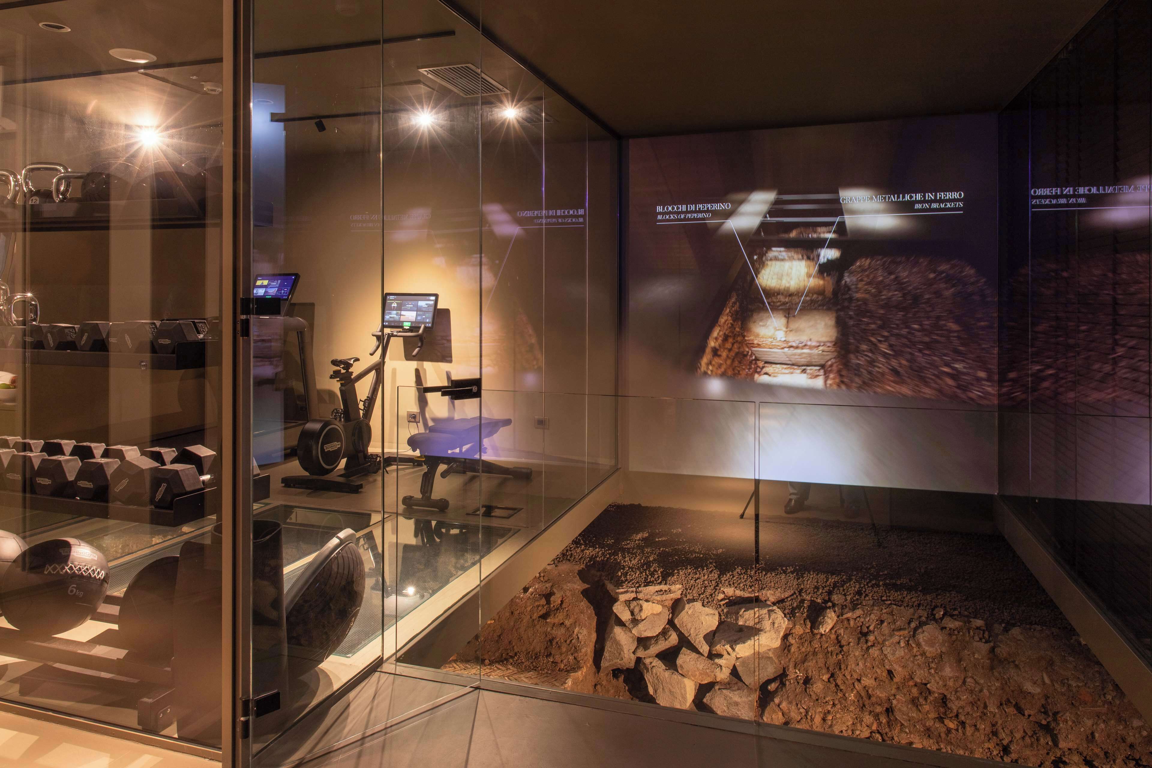 A modern interior with a treadmill, exercise equipment, and a digital display.