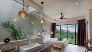 A modern hotel room with a large bed, a bathroom with a sink and mirror, and a view of the outdoors.
