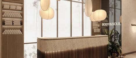A reception area with a wooden reception desk, hanging pendant lights, and a large window with bamboo patterns.