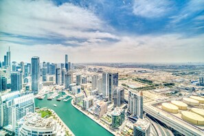 A high-rise urban area with modern skyscrapers, a marina, and a highway. - Address JBR - Mint Stay (Dubai)