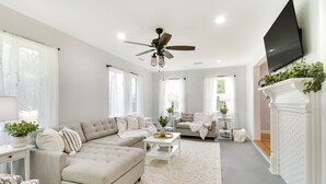 A spacious living room with a sectional sofa, a coffee table, and a fireplace. - Relax in a charming cottage near Nelson 151 featuring inviting living spaces and easy access to Virginia's wineries, breweries, hiking trails, and beautiful Blue Ridge scenery. (Afton)