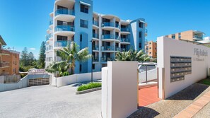 A multi-story residential building with balconies, a gated entrance, and a sign indicating 'Flightdeck 5-7 Clarence St.'