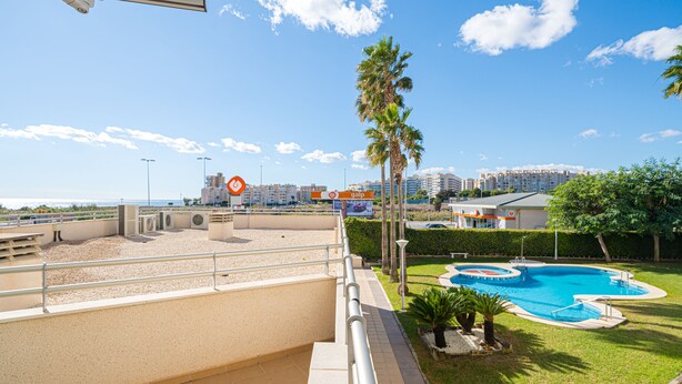 A pool area with a clear view of the surrounding buildings and a sign for a mobile network provider.