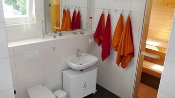 Shower, hair dryer, soap, toilet paper