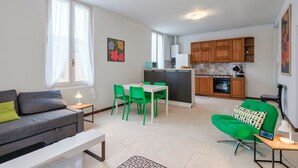 A modern apartment with a dining area, kitchen, and living room. - Via Cremona (Brescia)