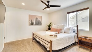 A bedroom with a bed, a ceiling fan, a window, and a nightstand. - Pool, Grill & Fire Pit: Pet-friendly Arizona Home (Lake Havasu City)