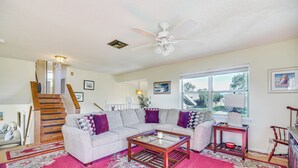 A living room with a sofa, coffee table, and a rug. - Sebastian Home w/ Large Deck Near Golfing & Beach (Sebastian)