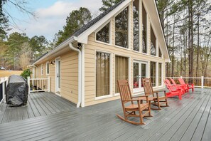 A wooden deck with a covered grill, a dining table with chairs, and a covered patio area. - Buckhead Home w/ On-site Lake Oconee Access! (Buckhead)