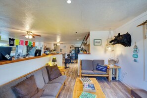 A cozy living area with a sofa, chairs, a coffee table, and a mounted animal head. - On-site Boat Ramp: Pet-friendly Kerens Studio! (Kerens)