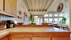 A kitchen with a wooden countertop, a coffee maker, and a hanging pot. - 1849 Condos 631 4 Bedroom Home by RedAwning (Mammoth Lakes)